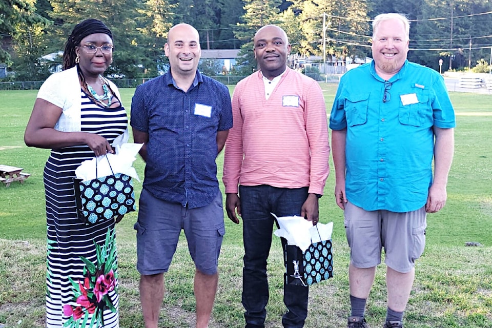 Dr. Sandra Okezue, MP Frank Caputo, Dr. Chibuikem Ofoegbu, and Mayor Merlin Blackwell visit at a celebration dinner last summer. The dinner was held for the physicians to celebrate a year where they faced incredible challenges including changes to how the medical clinic operates and staffing shortages at the hospital. See story page 6 and 7. (Shelley Sim photo)