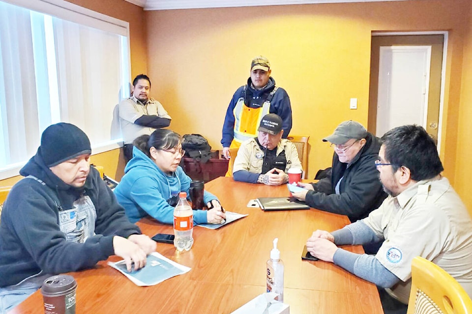 Kelly Wilson, left, and Mariah Myers from Williams Lake First Nation go over some details about searching for missing Bella Coola man Carl SChooner Jr. with Nuxalk Guardian Watchmen members Charles Saunders, Clayton Walkus, Roger Harris, and Ernest Tallio, right, and Rod Cahoose of Williams Lake, second from left, Tuesday, Jan. 31, 2023 in Williams Lake, . (Monica Lamb-Yorski photo - Williams Lake Tribune)