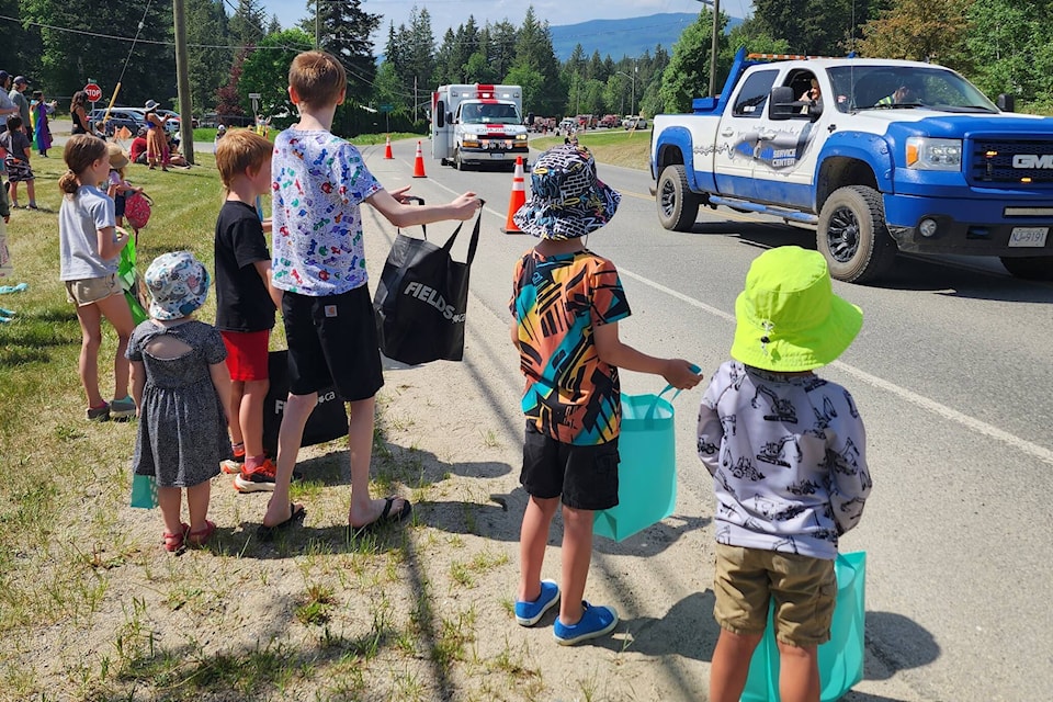 (Photo Credit) Hettie Buck Clearwater May Day Parade as the kids collect the candy and treats thrown by On Call Services