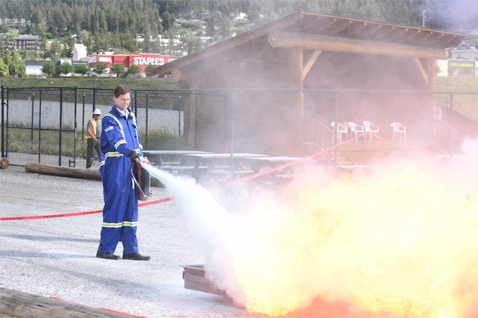Premier David Eby extinguishes a propane fire at one of the BC Mine Rescue Competition stations in Williams Lake on June 17, 2023. (Ruth Lloyd photo - Williams Lake Tribune)