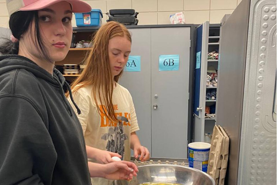 BSS Grad students, Ysabell and Makayla preparing breakfast for the school on June 21. (Photo by: Kris Luison, Secretary in Charge BSS)