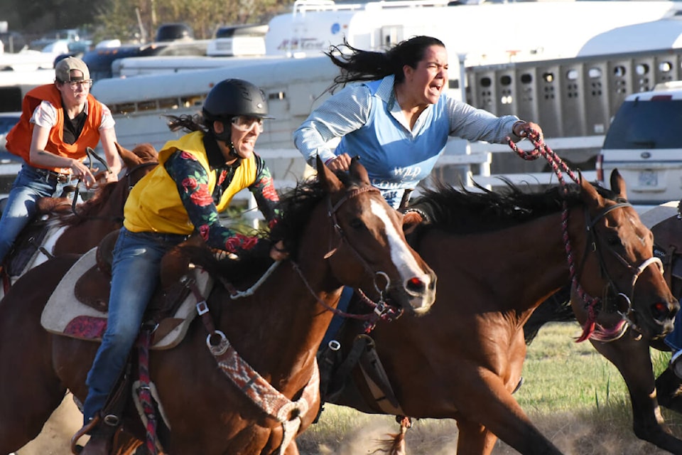 Heat 1 of the Williams Lake Stampede was a tight race Thursday evening, June 29. Lisa Parfiniuk, in yellow, and Amanda Lulua, far right, battle for the lead during the race. Parfiniuk, who is the 2022 champion, won the race and Lulua took second, giving both women a spot in the finals on Sunday. (Angie Mindus photo - Williams Lake Tribune)