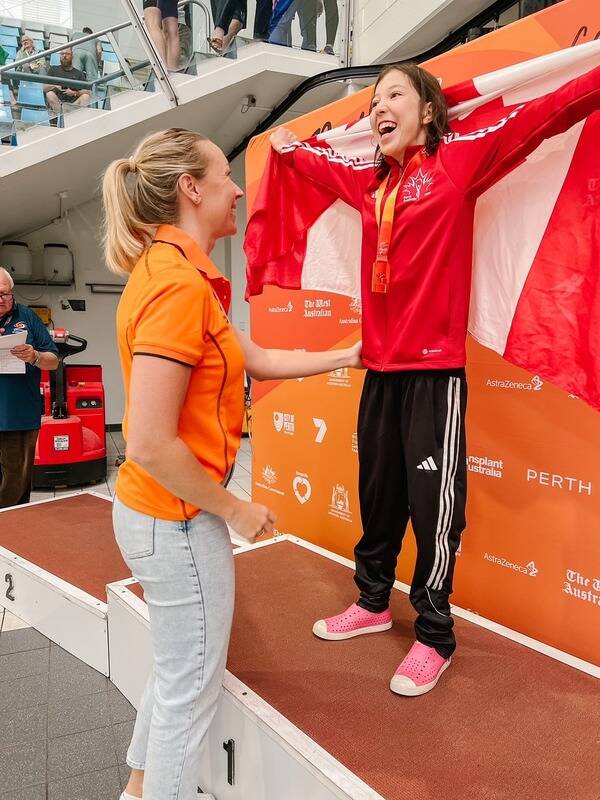 Addison waving the Canadian flag atop the podium at the World Transplant Games. (Kari Kylo/Contributed to ronaldomanosa)