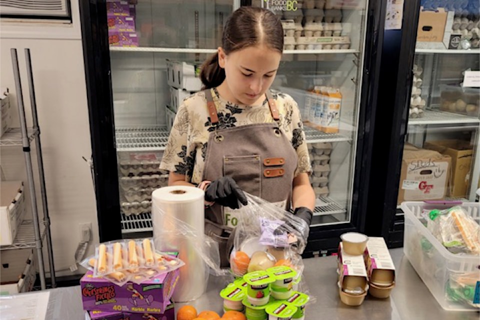 Barriere and District Food Bank youth volunteer Aurora Popil organizing 'Kids' Snack Packs' in the warehouse. 