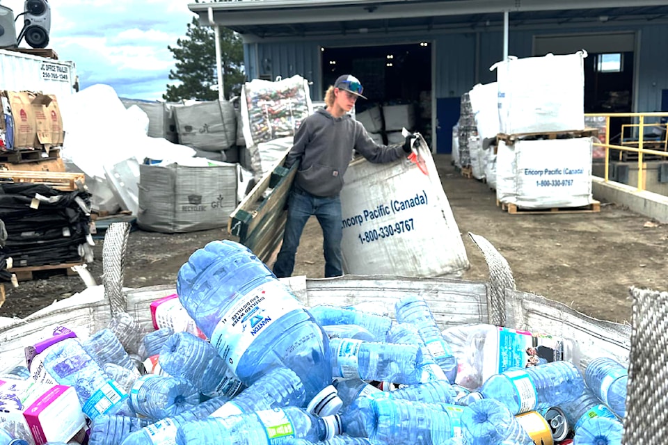 Corey Bourque working hard to raise funds for grad in Barriere during the bottle drive on Saturday.