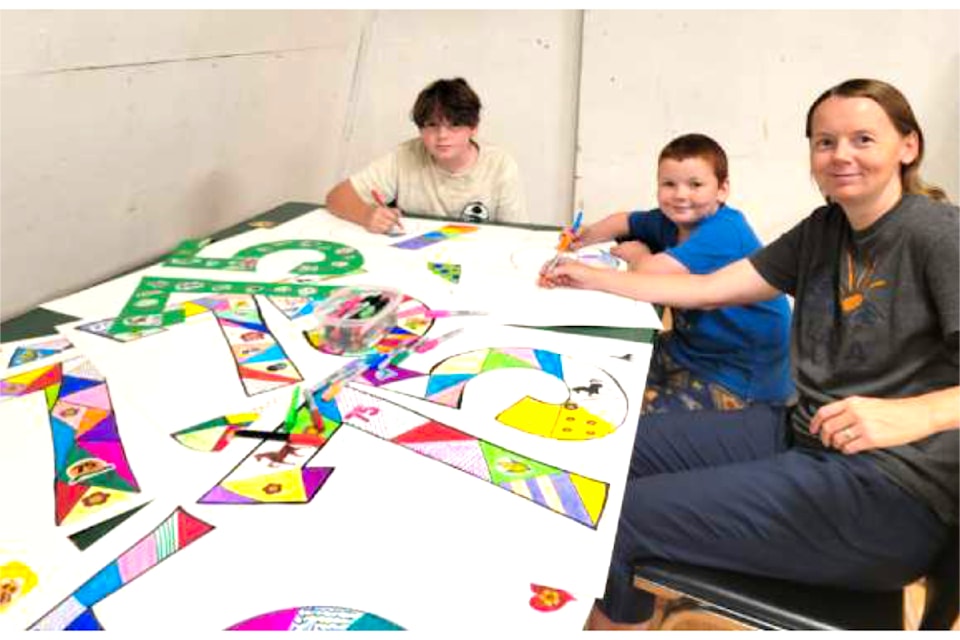 (From Left to Right): Liam, Cam and Tara Murphy creating posters for the 75th annual North Thompson Fall Fair and Rodeo.