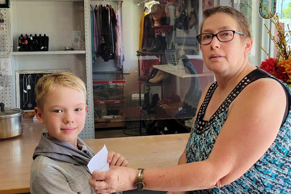 (From L to R): First Scouts of Barriere cub, Jade Brown receive a donation from Debbie Johnston of the Annex Thrift Shop. 
