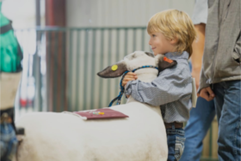 Dax Bouwmeester and friend hugging it out during the BC Ag Expo in Barriere over the weekend which ran from Sept. 20 thru 23. 