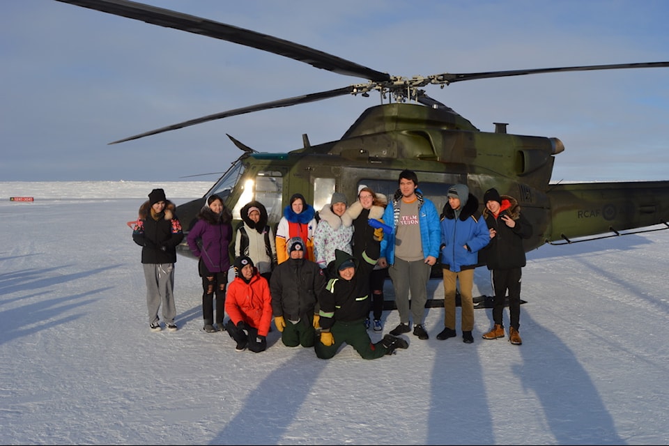A group of Junior Canadian Rangers get the chance to have a photo session with a military chopper that landed in Chesterfield Inlet years ago.