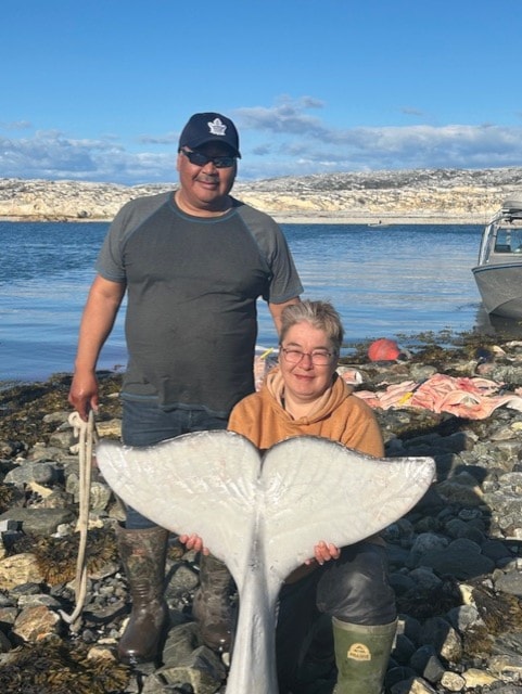 Corinne Pilakapsi proudly displays her first beluga whale as her husband, Aarron, looks on in Rankin Inlet last week. 