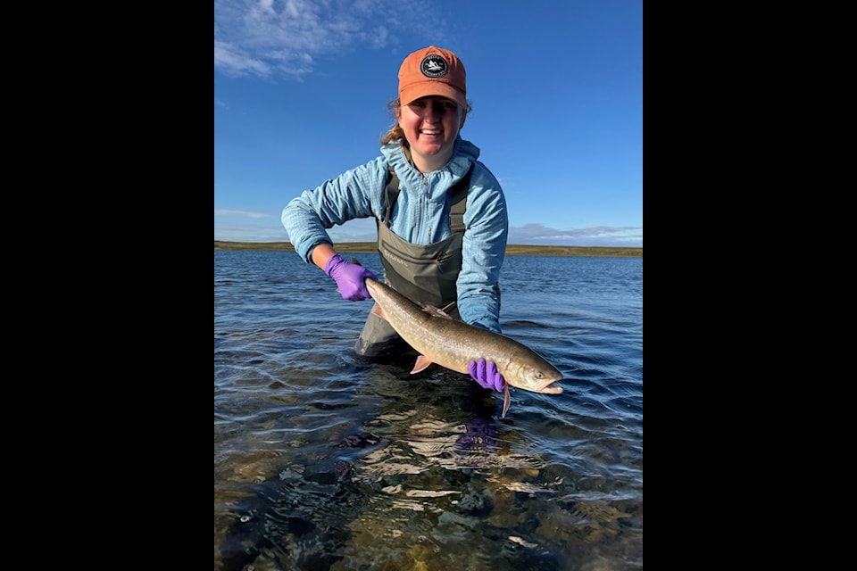 Amanda Olsen holds an Arctic char that was tagged and  released outside of Rankin Inlet earlier this summer.