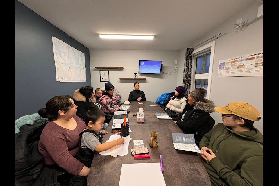 Participants listen to Kitikmeot Chamber of Commerce executive director Talia Maksagak, centre, and learned what the organization does, the opportunities that are available through the chamber, and how to join. From left, Tobi Qirnqnirq (with son Tommy), Cora Kavyaktok, Maryrose Tulurialik (with grandson Raymond),  Tobi Qirnqnirq (with Tommy), Talia Maksagak, Annie Oyakyoak, Susan Pryde and Corey Annaklik.
