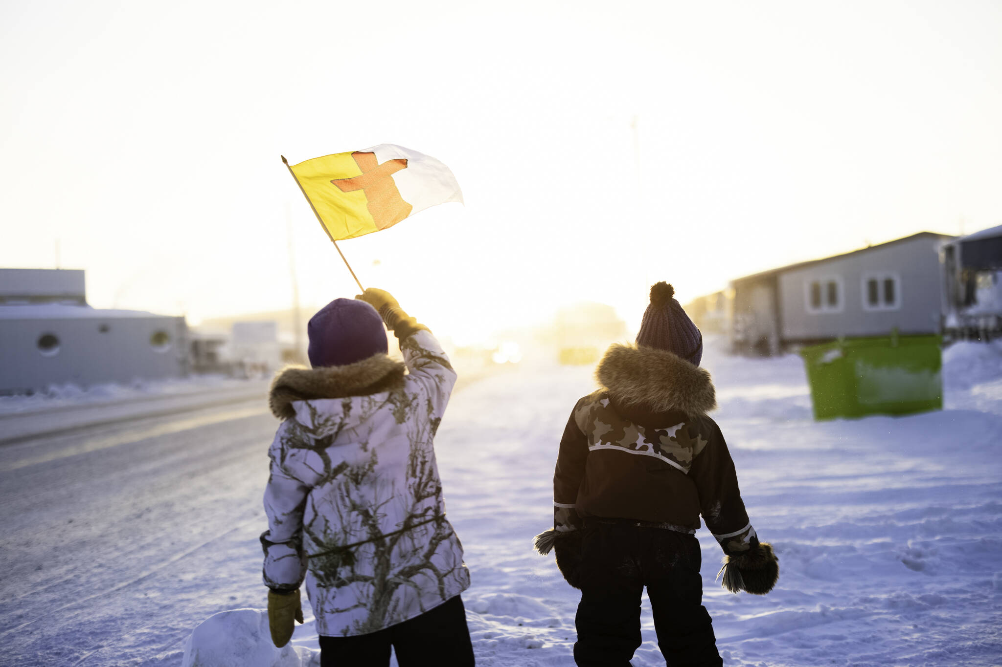 Wesley Jones and Ryerson Adams help welcome back our 2023 Arctic Winter Games athletes during a parade in Rankin Inlet on Sunday, Feb. 5. Stewart Burnett/NNSL photo