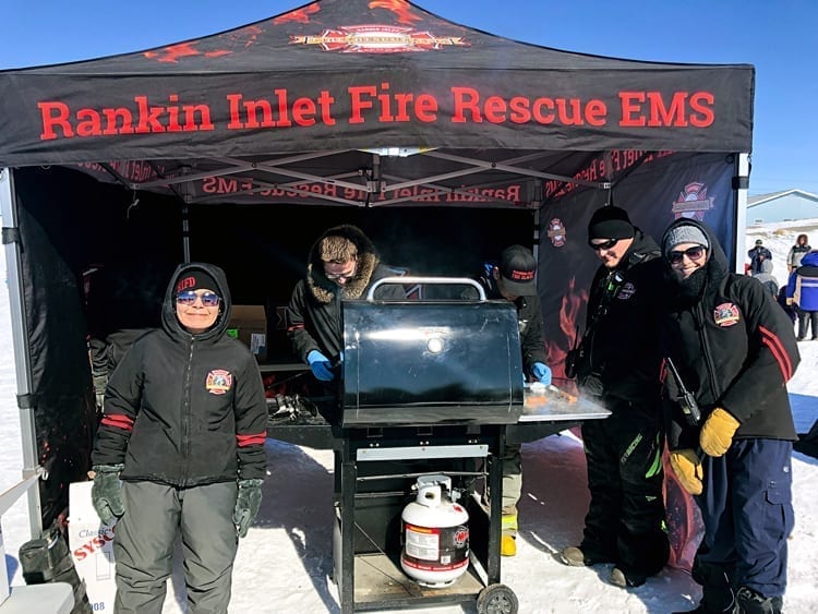Emergency services personnel, from left, Maryann Aksadjuak, Scott Morey, George Aksadjuak, Kyle Lowe and Hannah Hutchinson keep the tasty hotdogs coming during the third annual Easter Eggstravaganza in Rankin Inlet on April 20, 2019. Photo courtesy Mark Wyatt