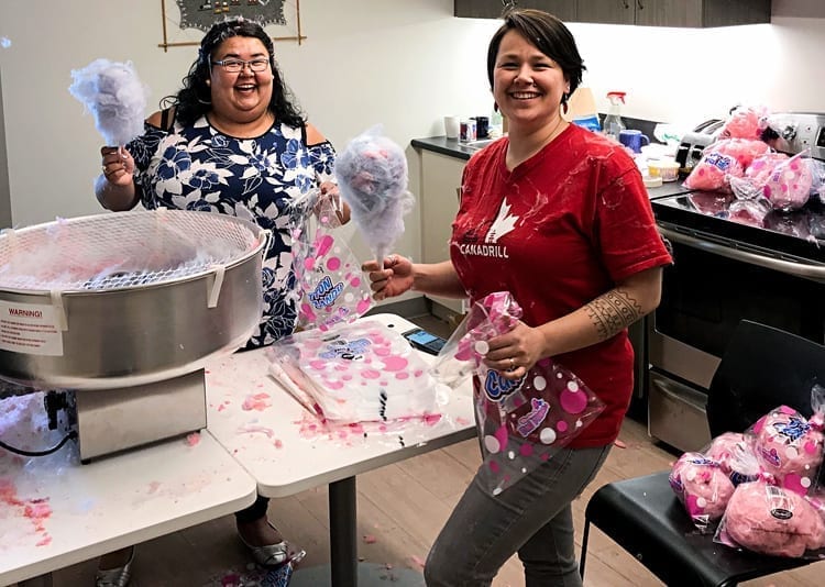 Lori Flynn, left, and Leslie (Inuujaq) Fredlund manage to get some of the cotton candy in the bags as help prepare for a kid's afternoon at Williamson Lake during Pakallak Tyme in Rankin Inlet on May 2, 2018. photo courtesy Jared Ottenhof