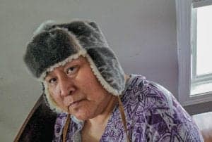 0309Josie Tucktoo<br /> Josie Tucktoo<br /> Cambridge Bay<br /> The artist modelling a hat she made.