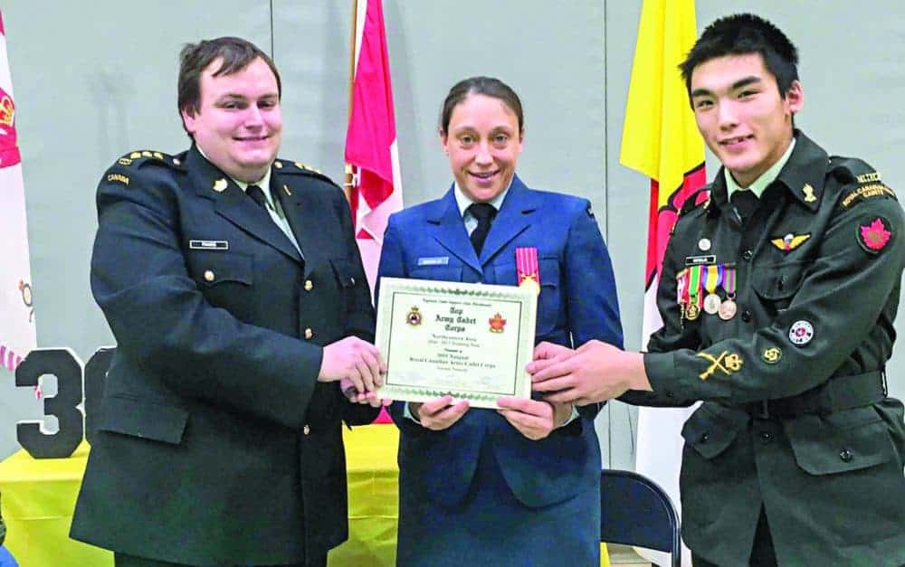 Cadet regional training officer Capt. Erin McKinlay, middle, presents 3055 RCACC commanding officer Capt. Lloyd Francis, left, and Chief Warrant Officer Terance Mapsalak with a certificate declaring the 3055 as the top army cadet corp in the Northeastern Area for 2016-17 in Naujaat in November of 2018. Photo courtesy Lloyd Francis