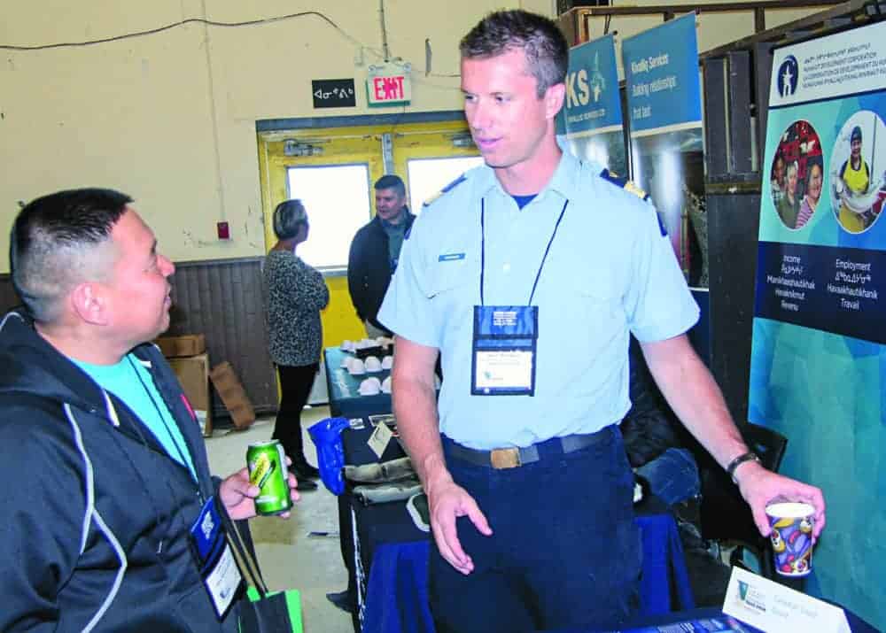 Cedric Autut, left, talks with Steve Thompson of the Canadian Coast Guard during the Kivalliq Trade Show in Rankin Inlet on Sept. 25, 2018. Darrell Greer/NNSL photo