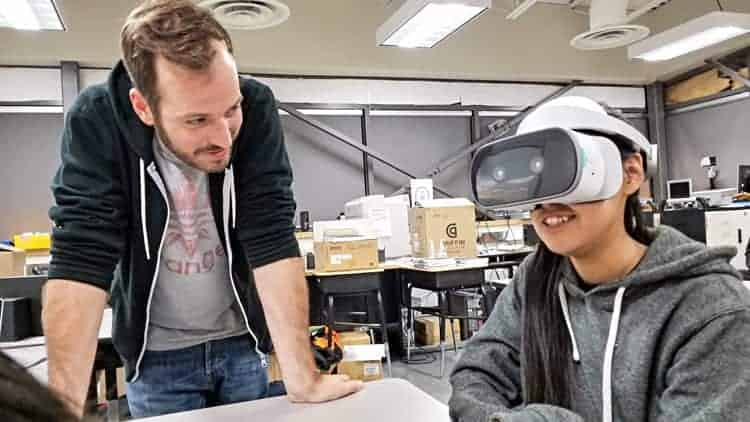German cinematographer Fabian Klein, left, watches as Edith Issakiark tries out a state-of-the-art virtual reality viewer during an Arviat Film Society meeting in Arviat on Nov. 1, 2018. Photo courtesy Gord Billard