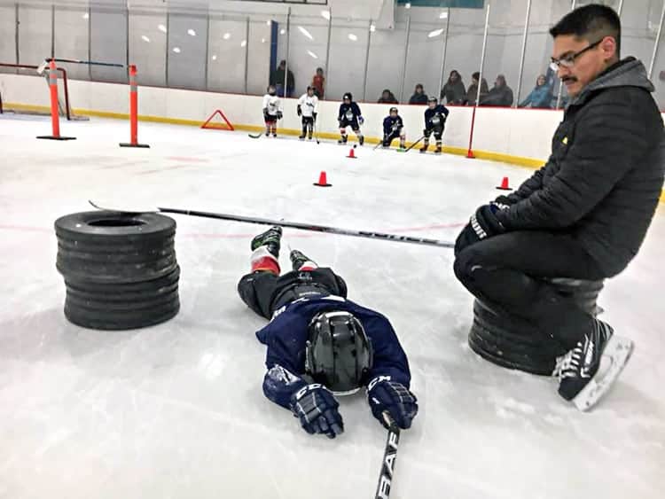 This little minor hockey player was plumb tuckered out by the time he reached instructor Aaron Kopak at the finish of his skating drill during the Rankin Rock Season Opener hockey camp (the second of three top player-development camps all ready held in the Kivalliq this season) hird player develpoin Baker Lake from Nov. 21-24, 2018. Photo courtesy Rankin Rock