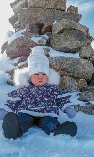 1504Amy Audlakiak.jpg Amy Audlakiak Qikiqtarjuaq My 11-month-old daughter enjoying fresh air behind an inukshuk. March 30, 2019.