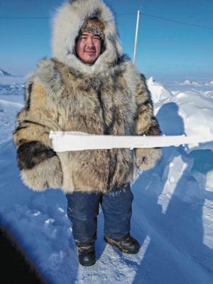 Lynn Emiktowt Arviat  1510Lynn Emiktowt_st1-3.jpg Nuatii Ishalook modelling the coat, I Lynn Emiktowt, softened and stretched the skins for, while his mom Maggie Manik sewed it - I helped a little with sewing.