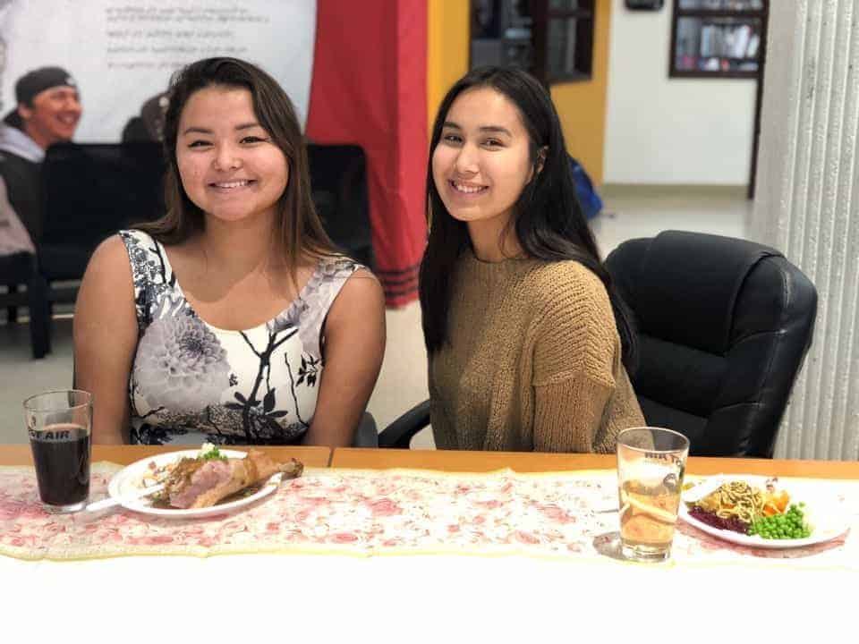 Second-year students Tooma Laisa, left, and Lena Korgak, both from Iqaluit, take a seat to enjoy their meal. Robyn Mo-Lian/Nunavut Sivuniksavut photos 