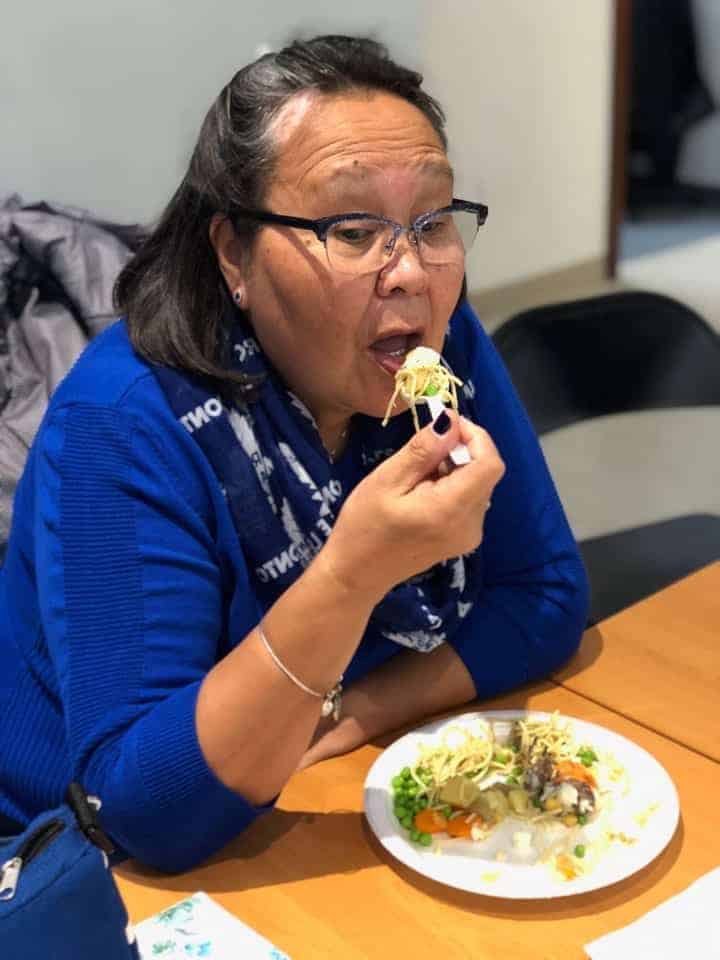 Nunavut Sivuniksavut instructor Meeka Kakudluk samples some of the delicious Thanksgiving Day cuisine. 