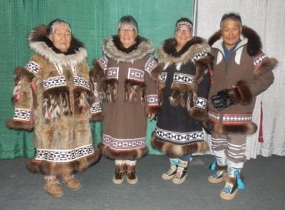 One of Kitikmeot's most skilled seamstresses is this family from Kugluktuk and Uluhaktok. Here is far left: Kate Kanayok Inuktalik, her daughter Susie Evyagotailak, Granddaughter Doreen Evyagotailak, and Son-In-Law Joe Allen Evyagotailak at a fashion show in Inuvik. The style of parkas are also Alaskan Inupiat style of coats and footwear. Navalik Tologanak/NNSL photo