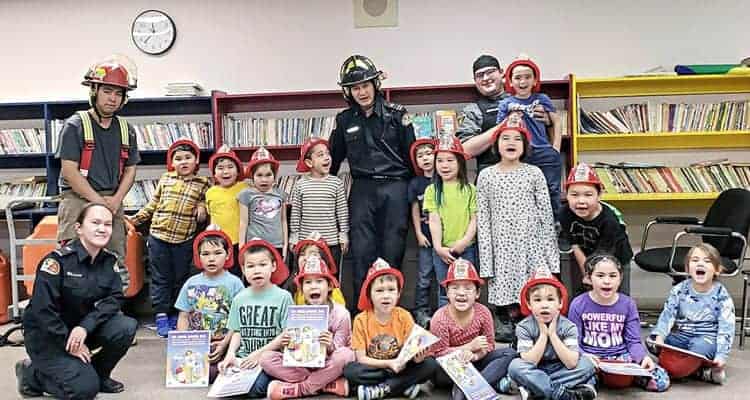 Capt. George Aksadjuak, back row from left, Fire Chief Mark Wyatt and Capt. Kyle Lowe join firefighter Catherine Tatty-Kabvitok, front left, to deliver their fire prevention presentation at Leo Ussak Elementary School in Rankin Inlet on Oct. 10, 2018. Photo courtesy Mark Wyatt
