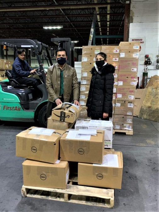 Archie Dedal, left, a Canadian North staff member moves packages destined for Cambridge Bay as Sudhir Jah and Isha Jah put some packages on a pallet. photo courtesy of Sudhir Jah