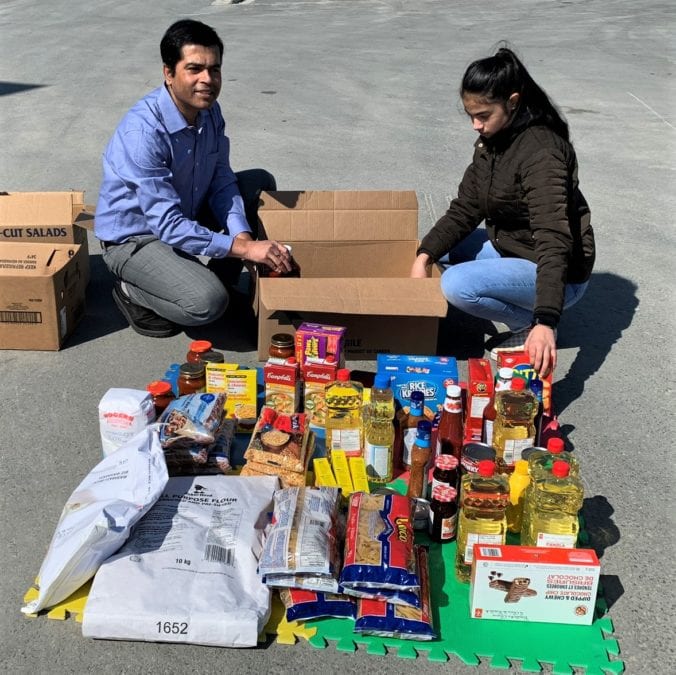Sudhir Jah, left, and his daughter Isha place food items into boxes before sending them to communities in the NWT in the summer. photo courtesy of Sudhir Jah