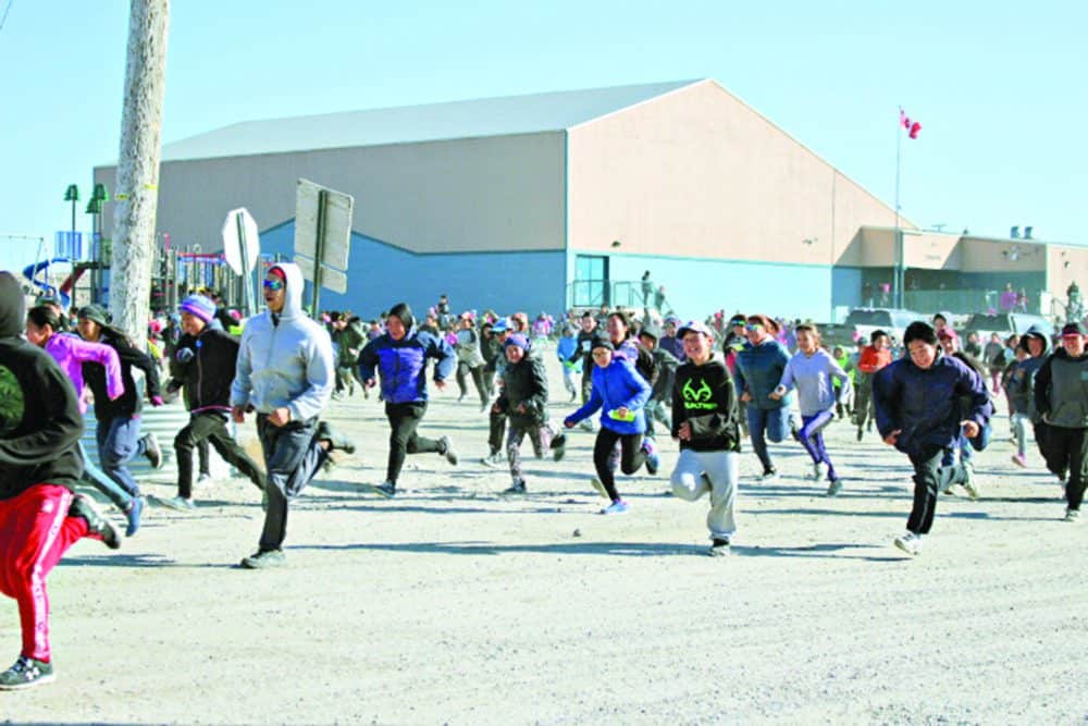 Students and staff members from both schools in the community take-off to run to raise money for cancer research during the annual Terry Fox Run in Naujaat on Sept. 7. photo courtesy Julia MacPherson