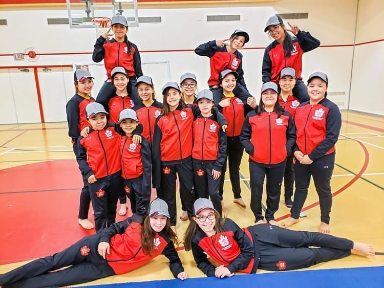 Members of the Rankin Inlet competitive gym team, back from left, Abby Mac Donald, Kylie Mae Aksalnik and AJ Libatique, and third row from left, Maya Hidalgo, Alyson McKay, Audrey Fredlund, Raegan Tattuinee, Nefretiri Innukshuk and Caroline Gibbons, and second row from left, Latasha Nirlungayuk, Yzabell MacDonald, Kortni McKay, Kyrene Angootealuk, Rachel Tutanuak and Josie Panika, and front from left, Lexus Dion and Bailey Green, are over the moon with happiness as they receive their Team Canada uniforms for the upcoming World Gymnaestrada in Austria in Rankin Inlet on Jan. 30, 2019. Photo courtesy Lisa Kresky