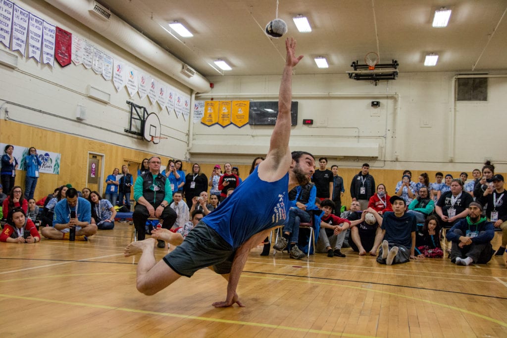 Arviat's Drew Bell reaches out to graze the sealskin ball during a record setting attempt in the one-hand reach at the 2018 Arctic Winter Games in Fort Smith, NWT. Bell's reach of 5 ft. 7 in. surpassed the previous record by one inch. NNSL file photo