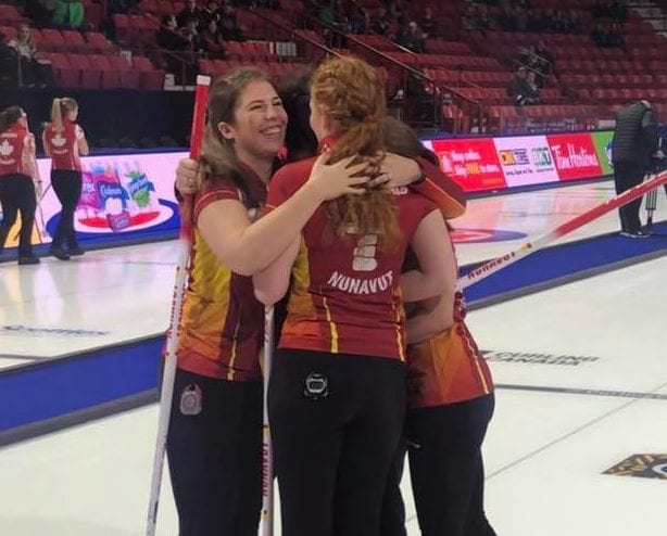 Sadie Pinksen of Iqaluit, left, joins in a celebratory hug with her teammates following Nunavut's upset win over Northern Ontario at the Scotties Tournament of Hearts in Moose Jaw, Sask., on Tuesday morning. Kyle Jahns/Curling Canada photo 