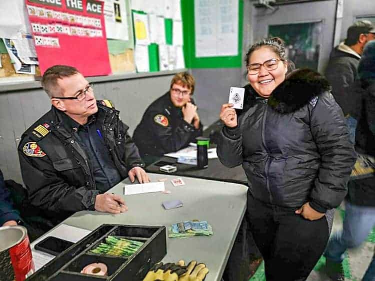 Fire Chief Mark Wyatt, left, smiles as Christal Kabluitok displays the Ace of Spades she drew during Chase the Ace at the Rankin arena this past Friday, Oct. 19, 2018. Photo courtesy Noel Kaludjak