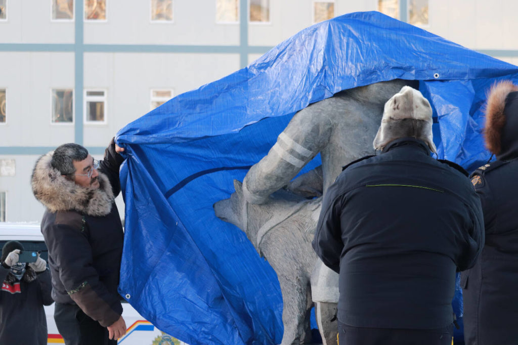                                             QIA president Olayuk Akesuk, left, along with RCMP officers unveil a statue dedicated to Inuit Special Constables and their sled dogs. Trevor Wright/NNSL photo                            
