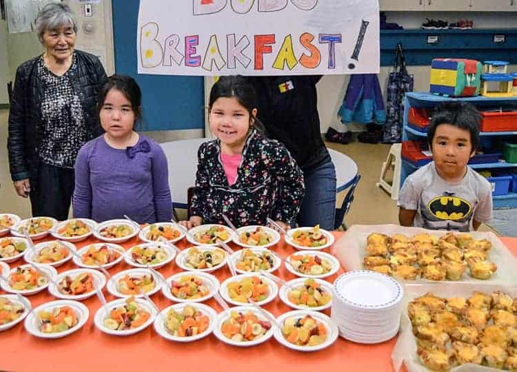 Teacher Rosalie Sammurtok, from left, and kindergarten students Felicia Makpah, Aaquaq Tanuyak and Kadluk Aggark are ready to enjoy an awesome breakfast thanks to Austrailian (Uncle) Bob Carveth at Victor Sammurtok School in Chesterfield Inlet on Nov. 19, 2018. Photo courtesy Glen Brocklebank