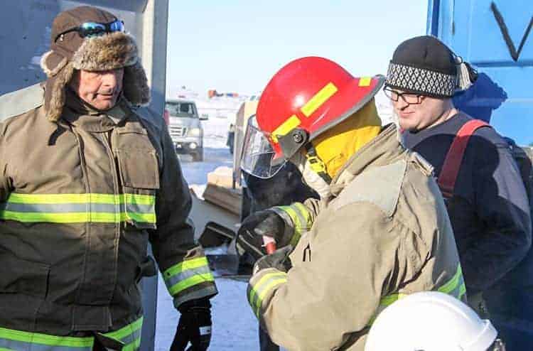 Brian Ukuqtunnuak prepares to strike the flare used to start a training fire as course instructor Gary Jarrett, left, and Rankin firefighter Kyle Lowe look on during fire-investigation training in Rankin Inlet on Oct. 25, 2018. Darrell Greer/NNSL photo
