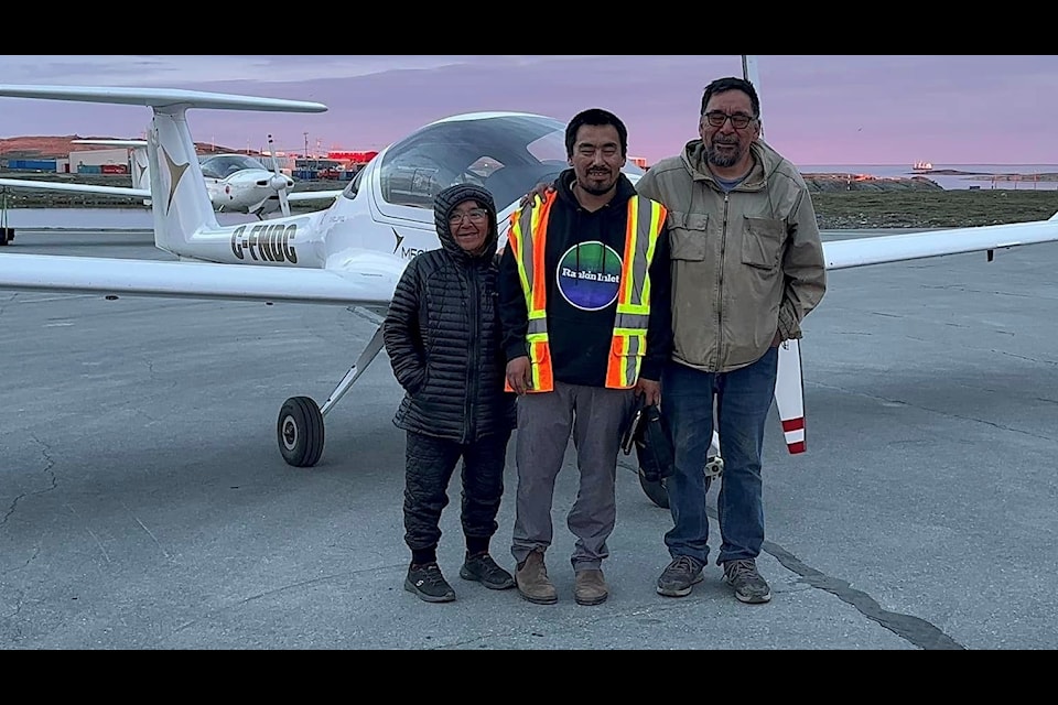 Proud parents Sam, right, and Bernadette, left, witnessed their son James, centre, take his first solo flight in Rankin Inlet on Sunday, July 14.