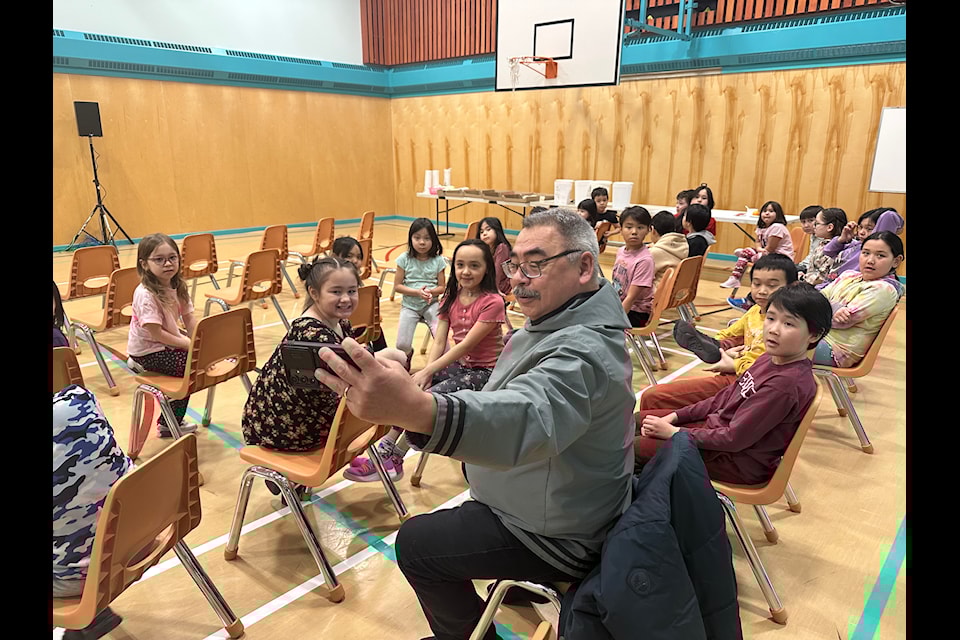 Justice Minister David Akeeagok takes a selfie with students from Nanook School during a funding announcement on Feb. 28. Kira Wronska Dorward/NNSL photo