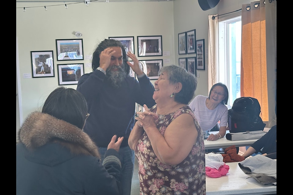 NDP leader Jagmeet Singh unveils his uncut long hair under the turban and explains the cultural relevance to a group of women at a sewing circle at Qajuqturvik Community Food Centre.