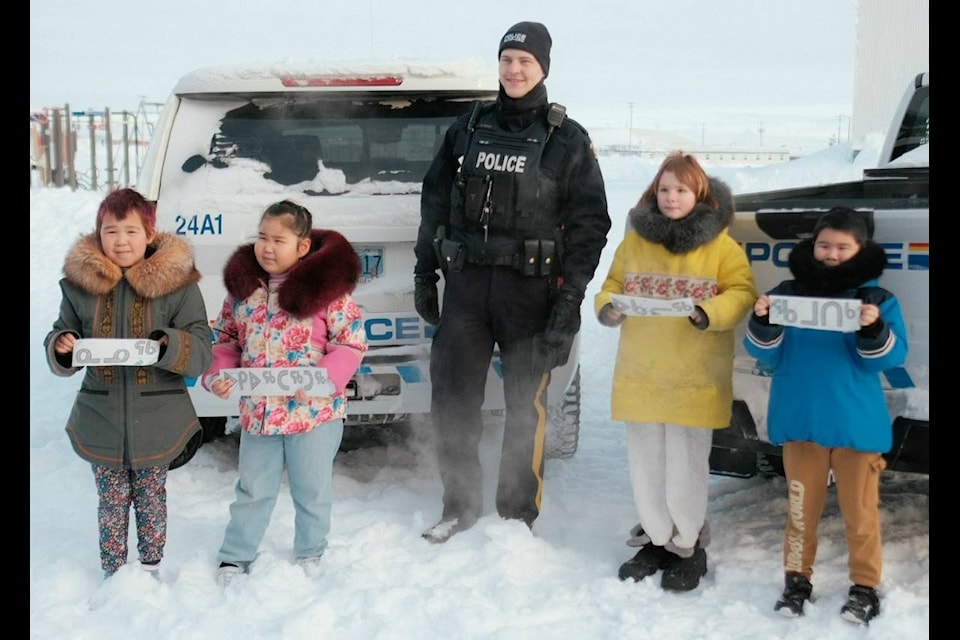 Const. Gabriel Stuart, of the Rankin Inlet detachment of the RCMP, middle, congratulates winners of the RCMP's Name a Police Truck contest, from left, Kesha Kolit, Lillian Pilakapsi, Katie Nordman and Mason Iguptak on Feb. 18.