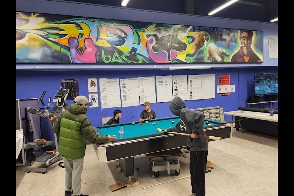 Two Iqallumiut square off at the youth centre's pool table.