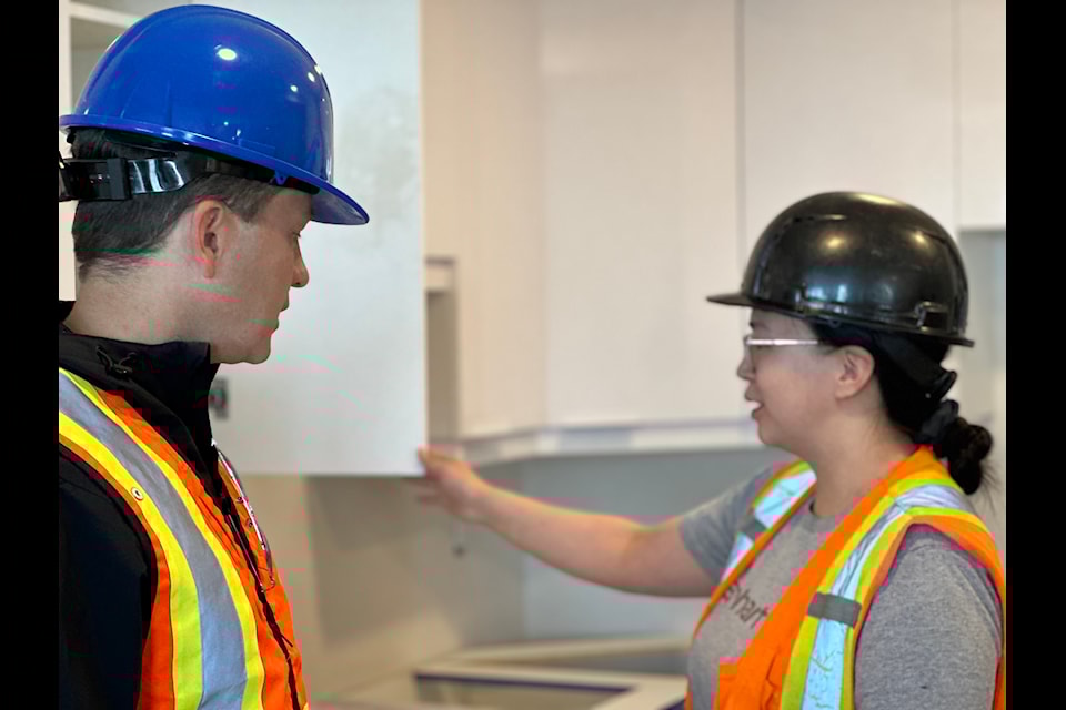 Pierre Poilievre assists apprentice Alicia Stewart with making a cabinet in a residential apartment during his stop in Iqaluit on Monday.