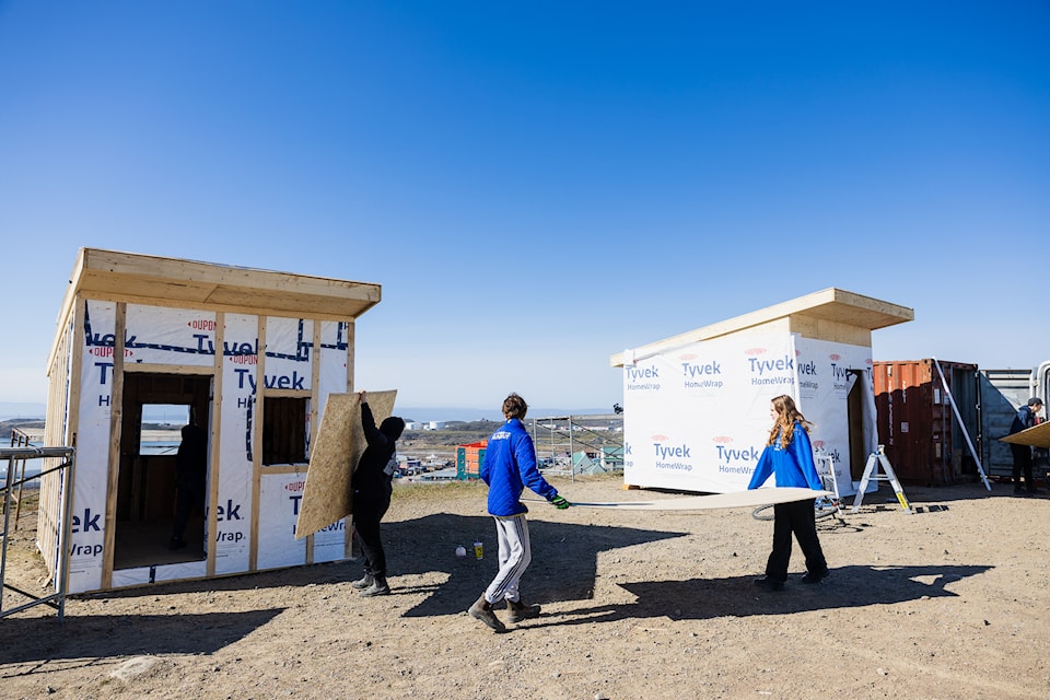 Students help on a construction site in Iqaluit.