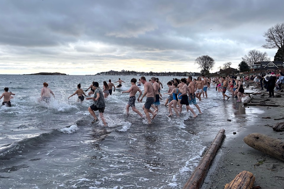 Hundreds darted into the water at Willows Beach on Jan 1.