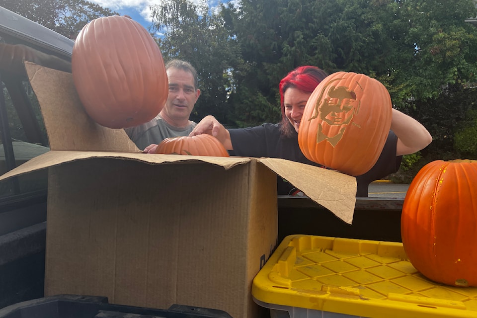 Darren Hughes, former Oak Bay fire chief and Kiwanis volunteer, and Heather Leary, with the Oak Bay Business Improvement Association, haul pumpkin art out of storage and sort between the gourds for sale and those that will light up along Oak Bay Avenue ahead of Halloween. 