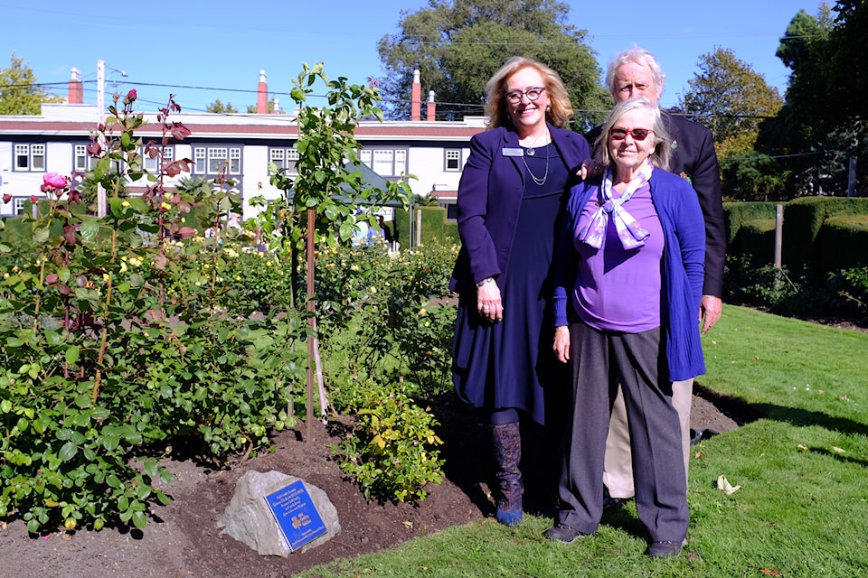 (L-R) Oak Bay Councillor Hazel Brathwaite, David Spence, president of the Royal Commonwealth Society Vancouver Island, and event organizer Margaret Lidkea pose beside two freshly planted rose bushes at a ceremony held by the Victoria Trefoil Guild and the Royal Commonwealth Society at Oak Bay’s Windsor Park Rose Garden on Sept. 29, honouring the late Queen Elizabeth II. (Olivier Laurin / Oak Bay News)